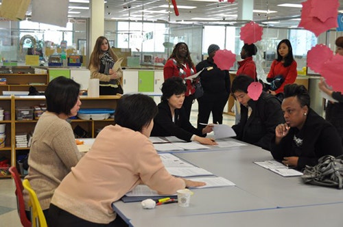 Human Services workers assist applicants with information about childcare at a job fair.