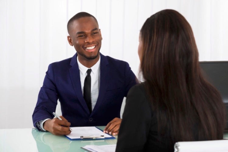 A smiling career counselor meets with a client.