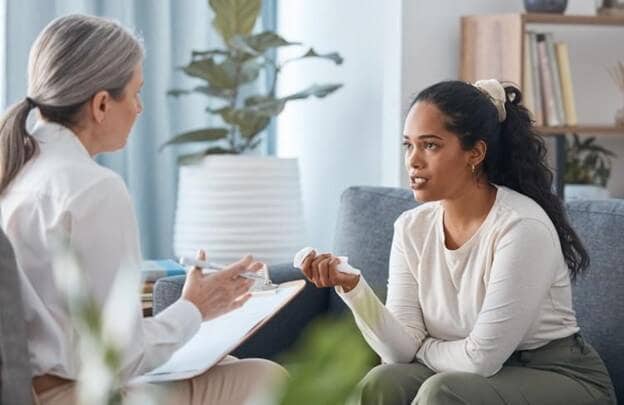 A person speaks with a counselor.