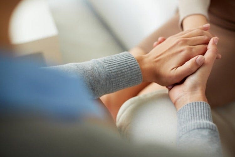 Two people clasping hands.