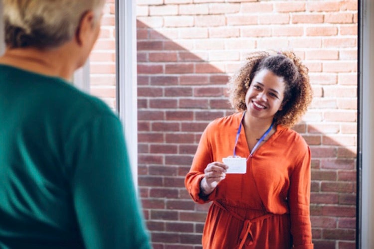 a lady introducing herself to a man at the door of his house