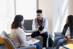A school counselor meets with two students.