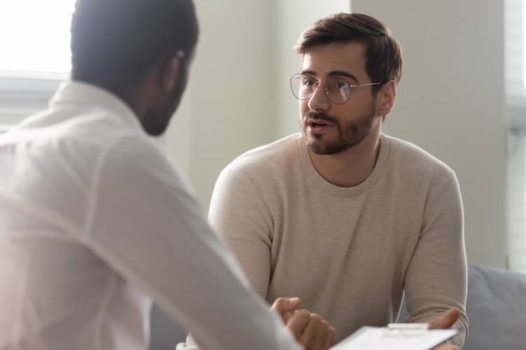 A mental health counselor meets with a patient.