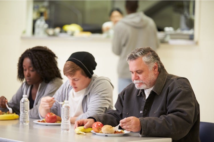 Group of people eating a meal in a cafeteria
