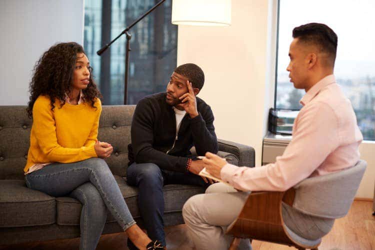 A marriage and family therapist counsels a couple.