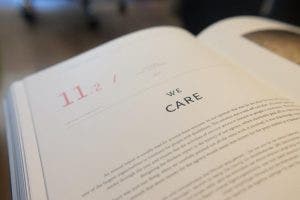 A book open to a page that reads “We care.”