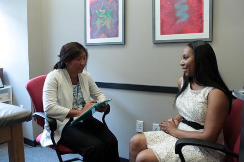 A counselor consults with a client in an office.